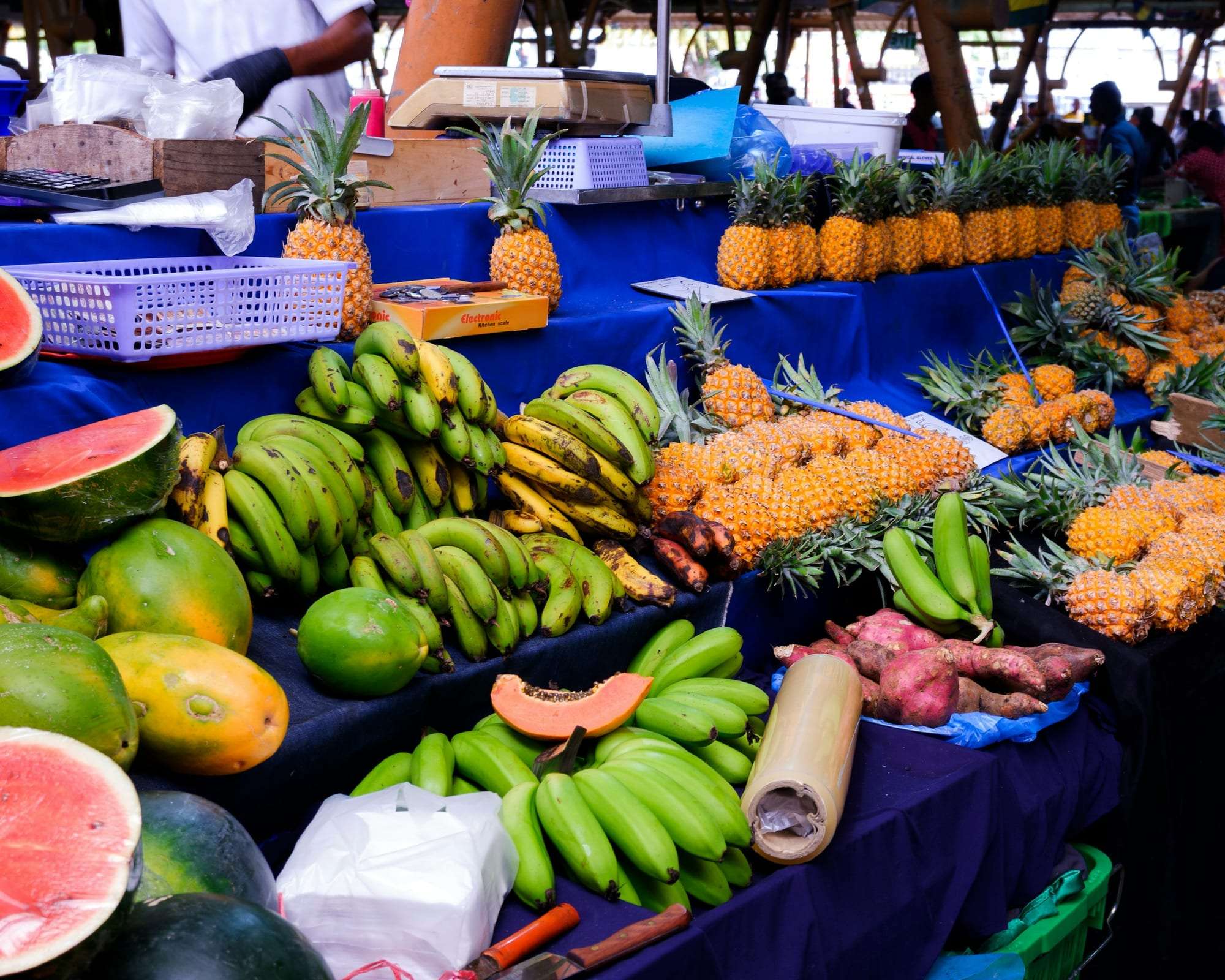 Fresh tropical fruit piled high on a market stall